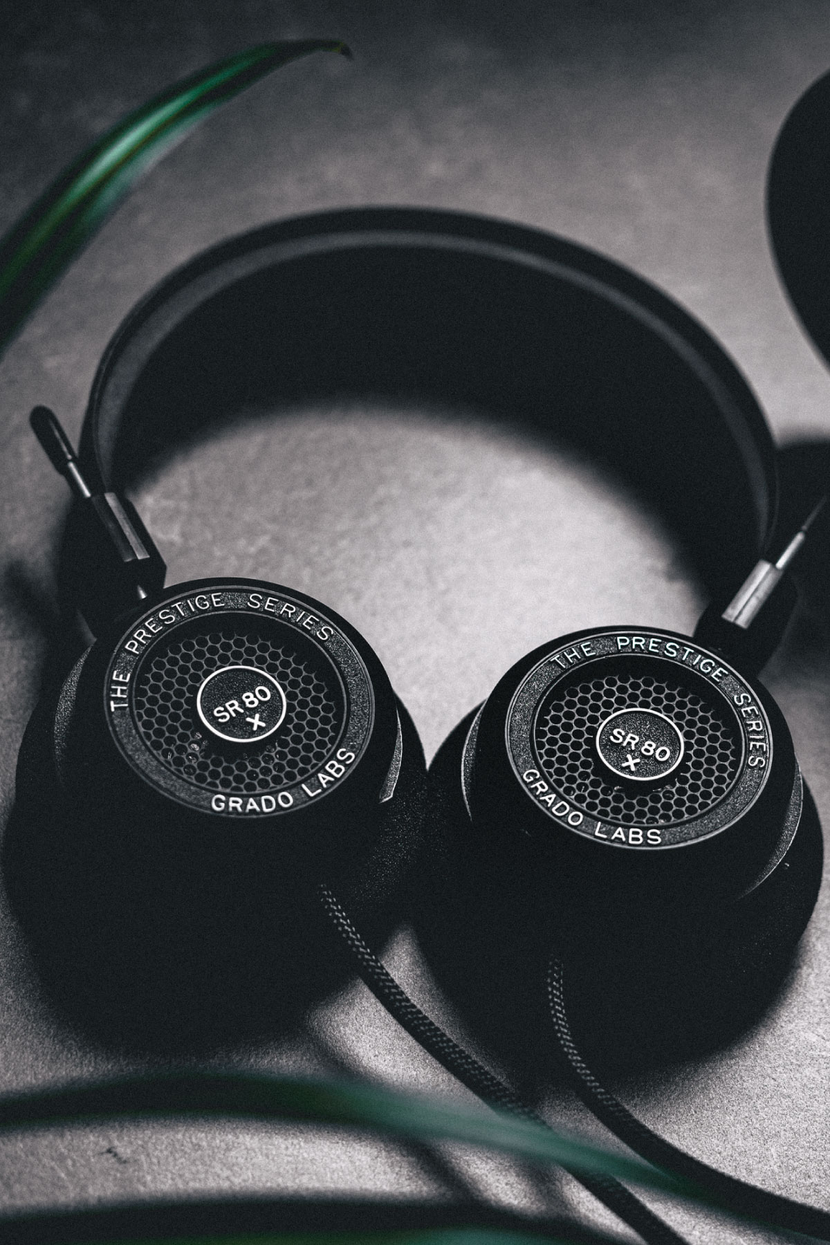 Photo of SR80x headphones resting on a black table