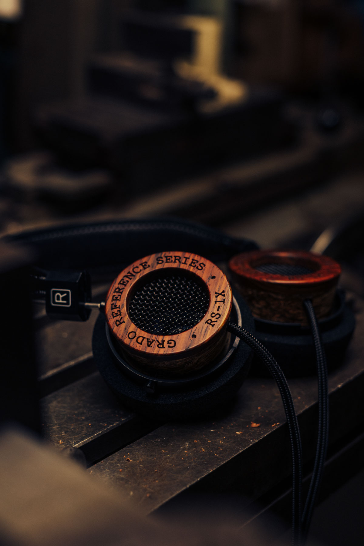 Closeup photo of the RS1 headphones resting on a workbench taken from the side.